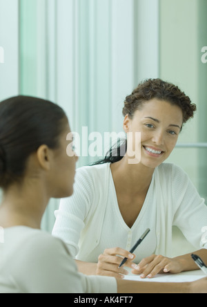 Two women working together Stock Photo
