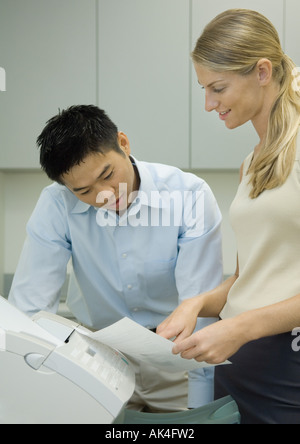 Office workers using fax machine Stock Photo