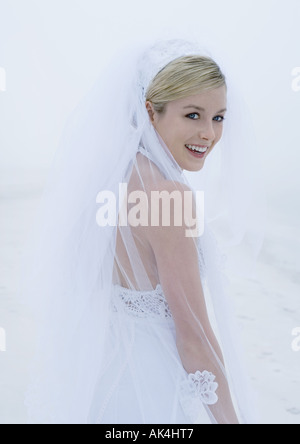 Bride looking over shoulder at camera Stock Photo