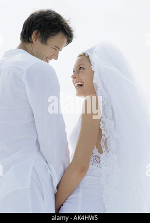 Bride and groom smiling at each other, low angle view Stock Photo