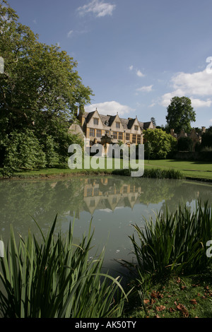 Stanway House in the Cotswold village of Stanway reflected in the lake on a summers day Stock Photo