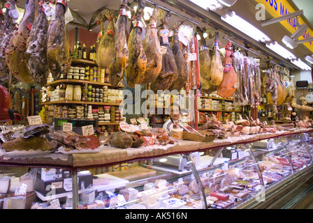 A delicatessen stocked with smoked hams hanging from the ceiling in the underground market at San Sebastian, Spain. Stock Photo