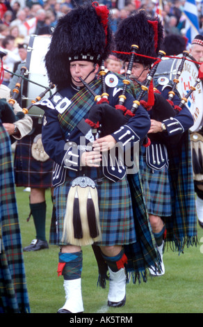 Pipers playing traditional music at a Highland Games event in Scotland Stock Photo