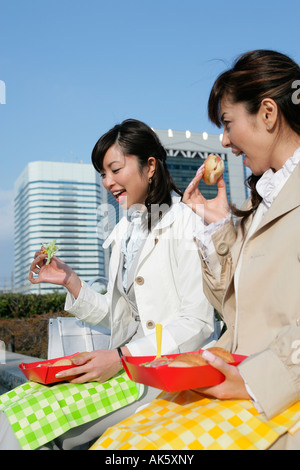 Two female office workers having lunch Stock Photo