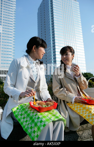 Two female office workers having lunch Stock Photo