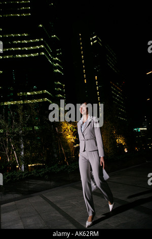 Woman walking alone at night Stock Photo