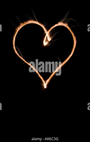 Heart shape made with sparkler at night Stock Photo