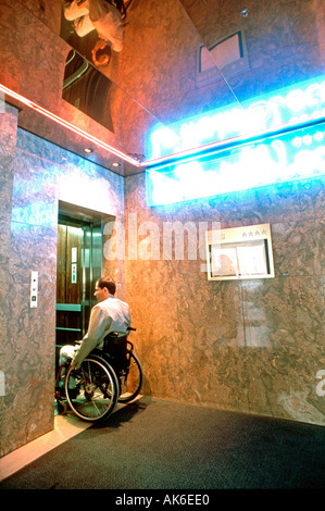 Paris France, Handicapped man in Wheelchair special needs access, entering to Elevator  "Le Train Bleu" Restaurant Electric Sign, neon sign door Stock Photo