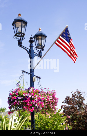 Hanging baskets and Flags on Main Street Lamposts in Frankenmuth Michigan MI Stock Photo