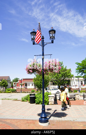 Hanging baskets and Flags on Main Street Lamposts in Frankenmuth Michigan MI Stock Photo