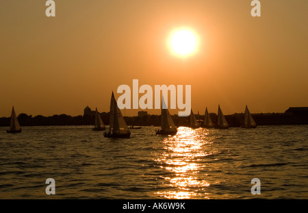 Sail boats on the Hudson River during a golden romantic sunset, New York USA Stock Photo