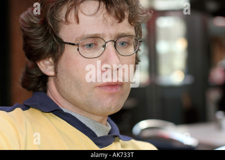 Unhappy young man in glasses Stock Photo