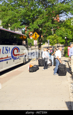 Bus picking up students leaving the University of Wisconsin Madison campus for the summer vacation Stock Photo