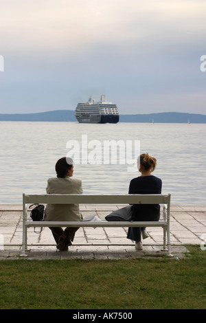 Two Women sitting on Bench looking out to sea Seafront Split Stock Photo