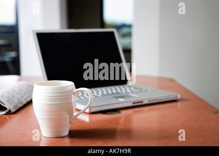 Laptop and Coffee Mug Stock Photo