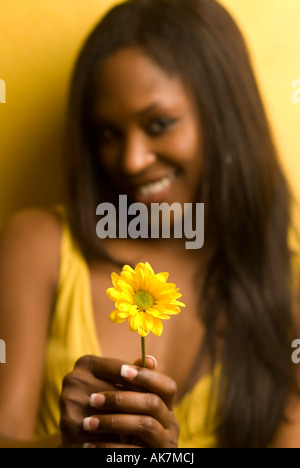 young woman smiling with flower Stock Photo