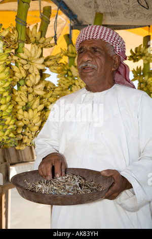 Selling Fish Abroad  Man wearing turban selling Selling Bananas and Fish Ras Al Khaimah UAE Stock Photo