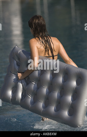 young woman with air mattress, Austria, Attersee Stock Photo