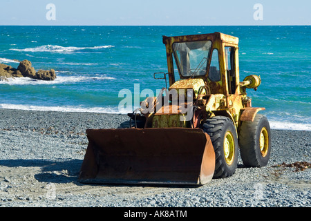 A tractor or bulldozer on the beach, Porthoustock, Cornwall Stock Photo