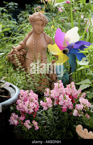 garden snapdragon (Antirrhinum majus), terrace with flowers and garden sculpture, Germany Stock Photo