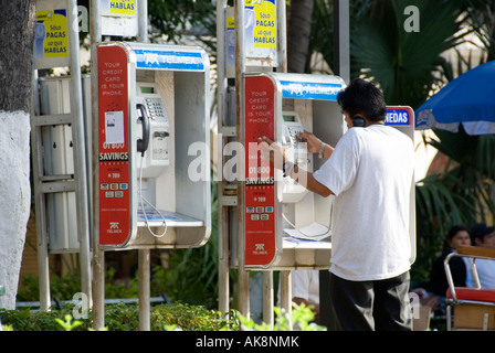 Merida, Mexico – Jan 16 2007: Mexican man using the public telephone at the Zocalo town square Stock Photo
