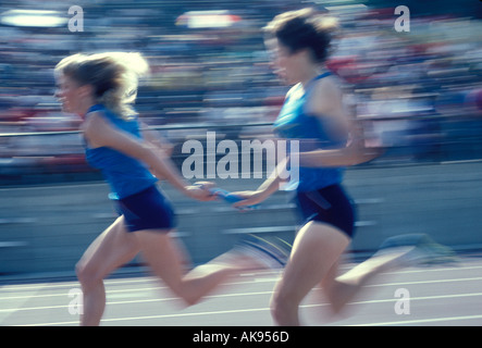 Baton pass in girls relay race at a Southern California track meet Stock Photo