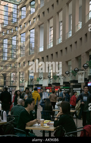 People at cafe tables in interior courtyard at Vancouver Public Library Vancouver BC Stock Photo
