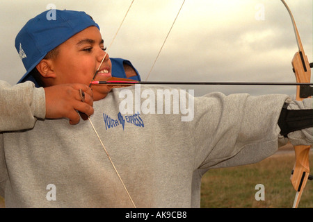 Archer age 12 firing his arrow on the Youth Express confidence course. Camp Ripley Minnesota USA Stock Photo