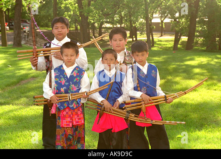 Hmong musicians age 12 holding traditional Hmong musical instrument at Taste of Frogtown Festival. St Paul Minnesota USA Stock Photo