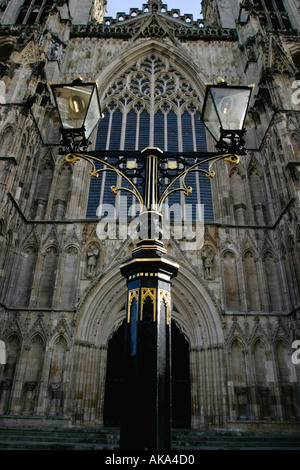 Ornate street lamp in front of new West Window at York Minster York Stock Photo