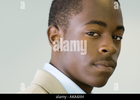 Young male looking at camera, sideways glance, portrait Stock Photo