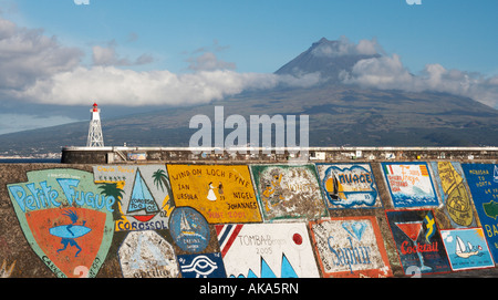 Horta marina wall on Faial island in The Azores with the nearby island of Pico in the distance. Stock Photo