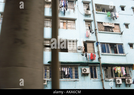 Apartment building with laundry hanging in front of windows Stock Photo