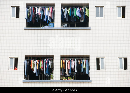 Laundry hanging to dry in balconies of apartment building Stock Photo