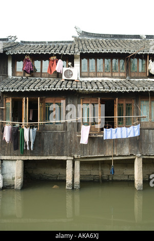 China, Guangdong Province, houses along canal Stock Photo