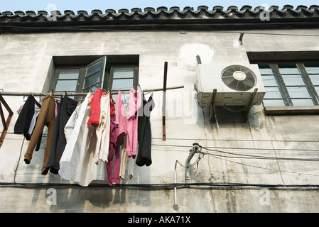 Laundry hanging out to dry below window, low angle view Stock Photo