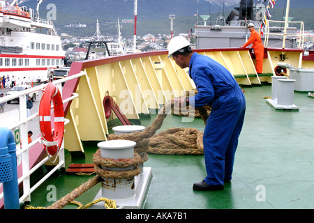 Deckhand on a ship making fast the mooring lines Stock Photo