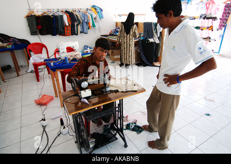 Maldives man behind sewing machine Stock Photo