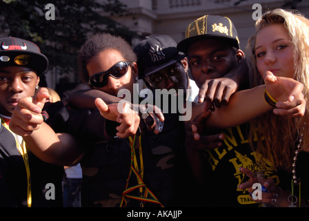 gang of lively young lads mucking about in streets of Notting Hill west london at carnival time. Stock Photo