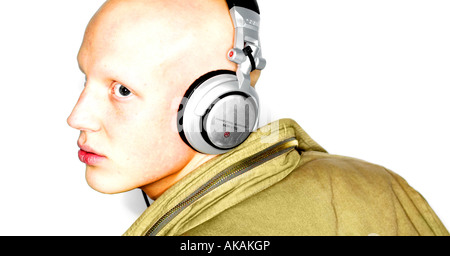 white male albino headphones music bold clothing jacket layers listening looking over his shoulder Stock Photo