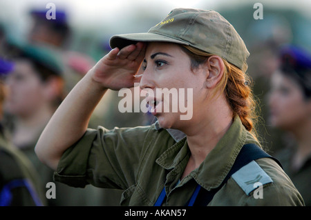 An Israeli female soldier salutes during a military ceremony on the last day of Israeli occupation in Gaza strip Stock Photo