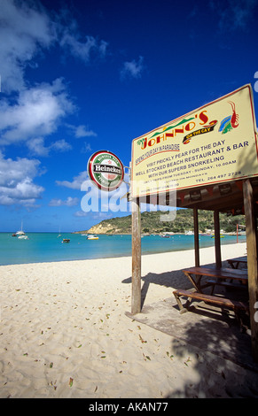 White sandy beach and wooden bar  with a Heineken sign Anguilla Caribbean Stock Photo