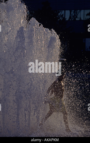 Salmon Street Springs fountain summer fun with boy playing in fountain at sunset Portland Oregon State USA Stock Photo