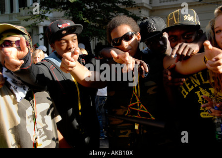 gang of lively young lads mucking about in streets of Notting Hill west london at carnival time. Stock Photo