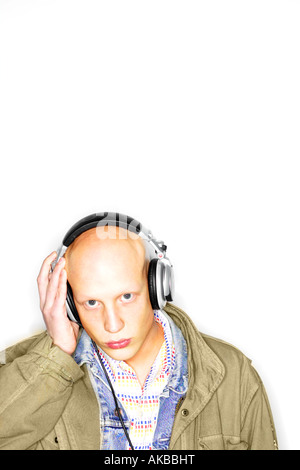 white male albino headphones music bold clothing jacket layers listening Stock Photo