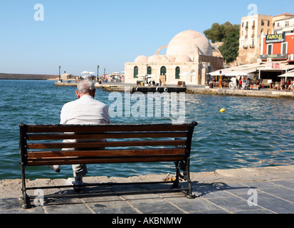 An elderly man enjoys the view at Hania harbour Crete Greece Stock Photo