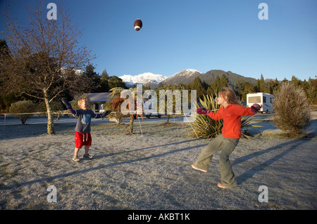 Children Playing Rugby in the Frost Frans Josef Glacier Campground West Coast South Island New Zealand Stock Photo