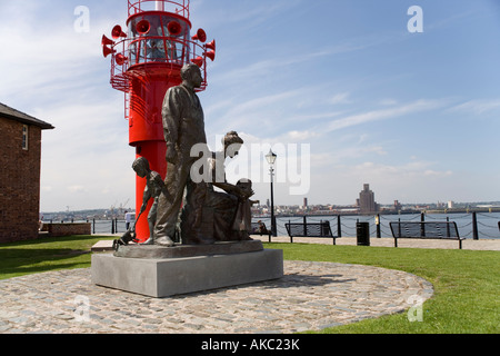Statue to the Emigrants who left the port of Liverpool,on the Riverside Walk by the Albert Dock and the Mersey River, Liverpool Stock Photo