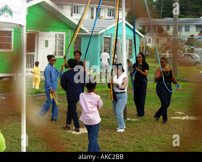 Women perform a traditional maypole dance weaving a pattern on the pole ...