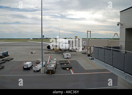air canada jet at departure gate of ottawa airport with ground support vehicles. Stock Photo
